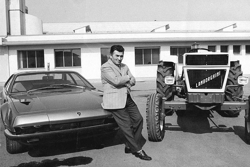 History of Lamborghini: Ferruccio Lamborghini standing between a Lamborghini car and a tractor.